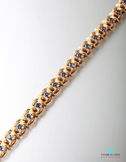 null 750-thousandths yellow gold bracelet with square guilloché gold shuttle links...