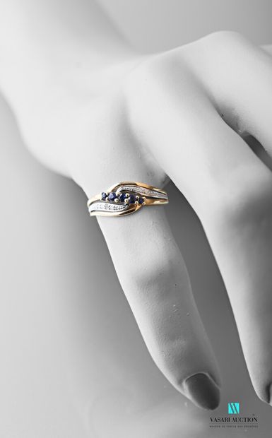 null 750-thousandths white and yellow gold ring with an openworked, animated body...