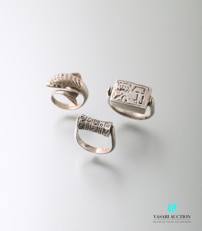 null Set comprising three silver rings, one of which depicts a dolphin, the other...