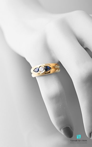 null 750 carat yellow gold ring set with a central brilliant set with two pear-cut...