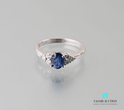 null A 750 thousandths white gold ring centered on an oval-shaped sapphire calibrating...