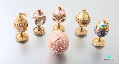 null Six eggs mounted in gold metal, enamel and set with imitation pearls or stones...