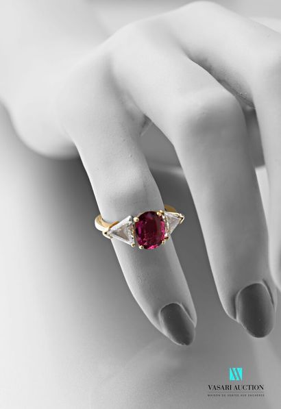 null 750 thousandths yellow gold ring set in the centre with a ruby shouldered with...