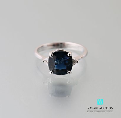 null 750 thousandths white gold ring set in its centre with a cushion-cut sapphire...