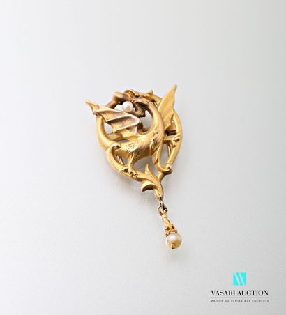 null Yellow gold 750 thousandths clip with a motif of a dragon devouring a pearl,...