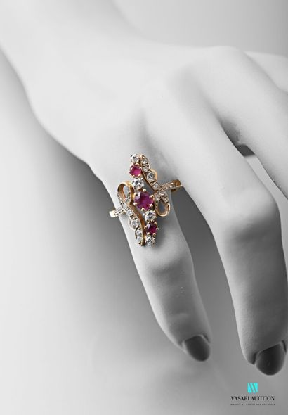 null Ring in 750-thousandths yellow gold, elongated motif set with three rubies alternating...