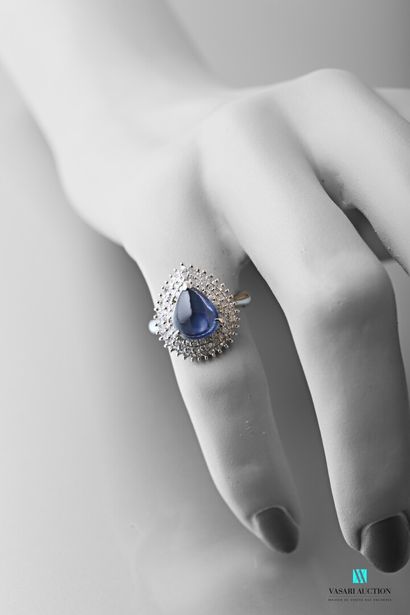 null 900-thousandths platinum ring set with a pear cabochon-cut sapphire calibrating...