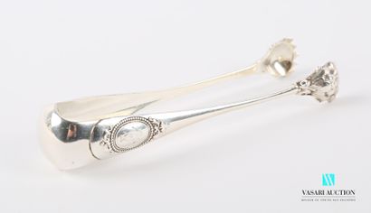 null Silver sugar tongs, the arms surmounted by medallions hemmed with pearls and...
