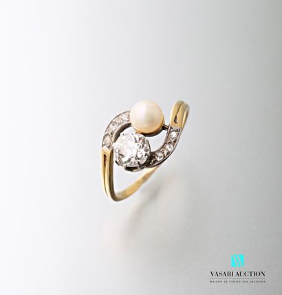 null A yellow gold ring Toi et Moi set with a 0.55 carat old cut diamond and a pearl...