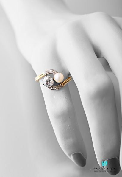 null A yellow gold ring Toi et Moi set with a 0.55 carat old cut diamond and a pearl...