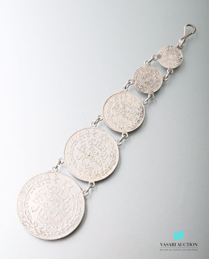 null Silver pendant decorated with five Tunisian coins arranged in fall.

Length...