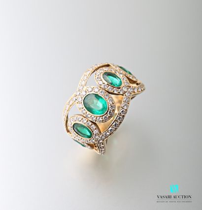 null Ring in yellow gold 750 thousandths decorated with emeralds in a frame of diamonds...