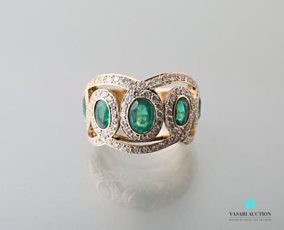 null Ring in yellow gold 750 thousandths decorated with emeralds in a frame of diamonds...
