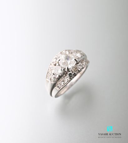 null A platinum ring set with three rows of diamonds, the central one being an old-cut...