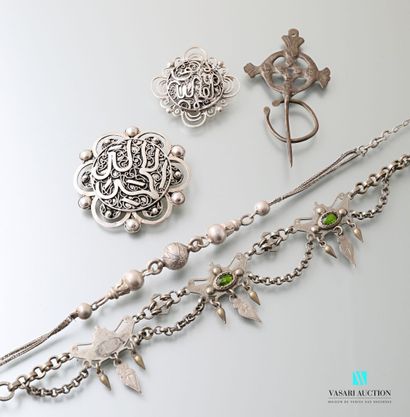 null Silver lot comprising two brooches with calligraphic motifs in its center decorated...