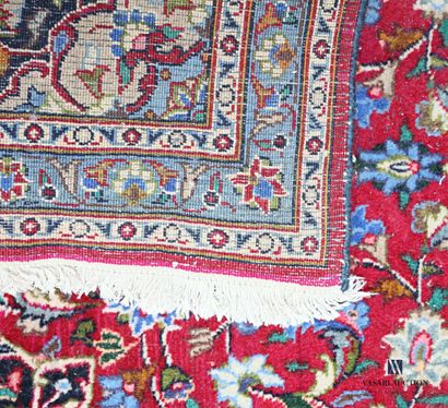 null Woolen carpet decorated with a central medallion inscribed in a frame of flowering...