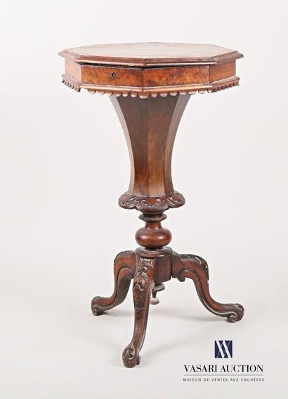null Working table in natural wood, moulded and carved and veneered, the octagonal...