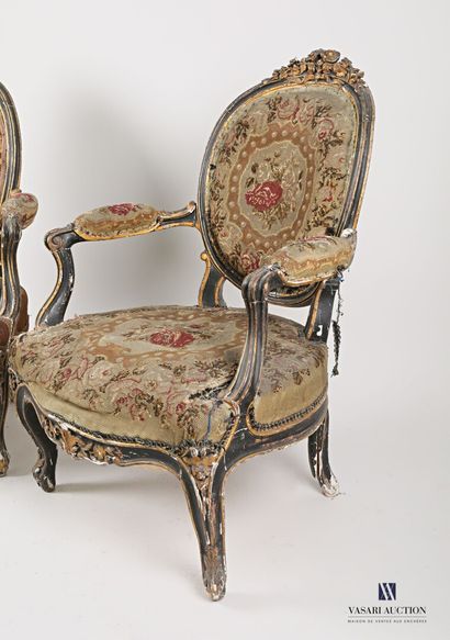 null Pair of armchairs in moulded, carved, blackened and rechambered natural wood....