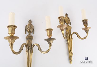 null A pair of ormolu sconces with two arms of light topped by a fire pot, the shaft...