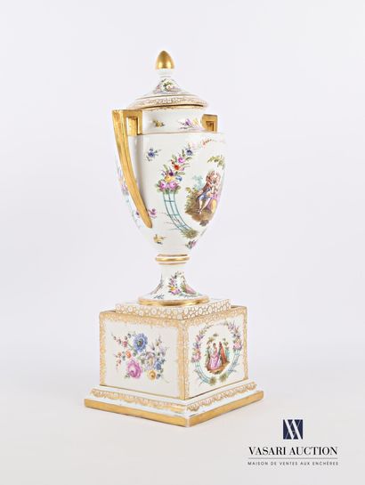 null White porcelain urn with gold highlights, the body with polychrome decoration...