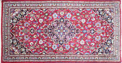 null Woolen carpet decorated with a central medallion inscribed in a frame of flowering...
