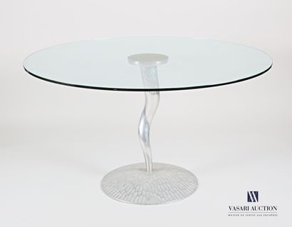 null Round table with a translucent glass top, resting on a sinusoidal base with...