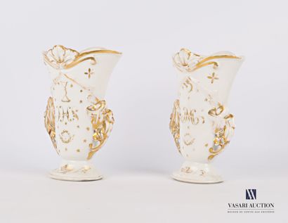 null A pair of white porcelain horn vases with gold highlights, standing on a doucine...