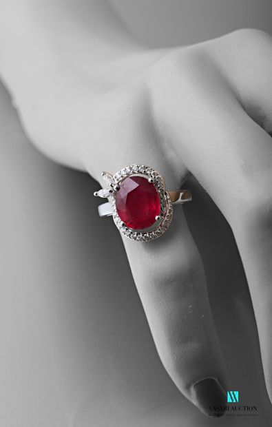 null Ring in white gold 750 thousandths decorated with a treated ruby of oval size...