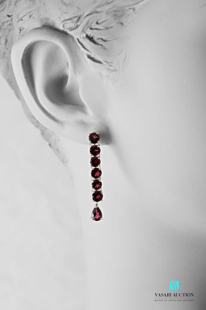 null Pair of silver earrings 925 thousandths each set with six round garnets holding...