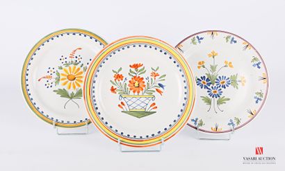  Set of three earthenware plates with polychrome decoration of flowers in the basin...