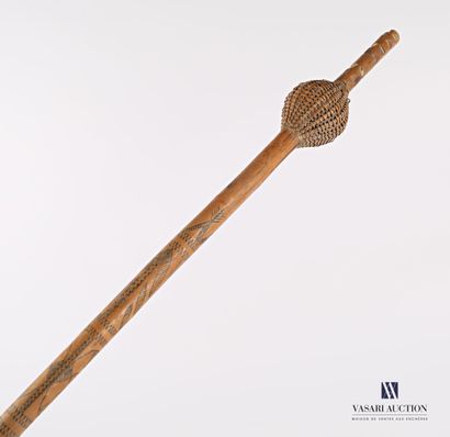 null Wooden and woven wicker cattail with bell, the shaft engraved with geometric,...