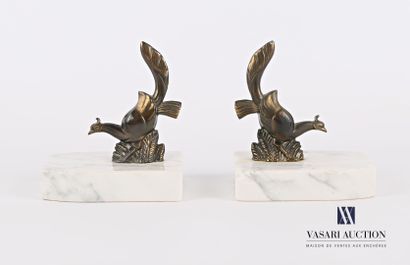 null A pair of bookends featuring two pheasants in regula with a medallic patina...