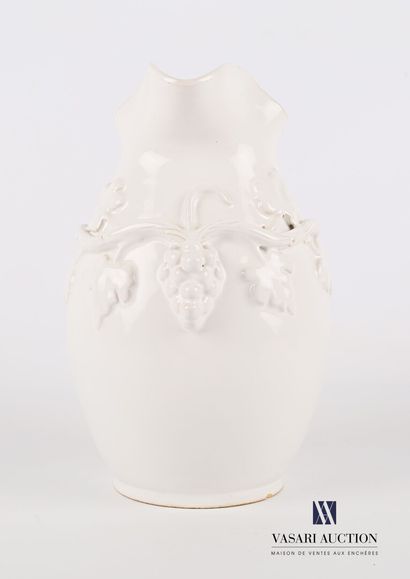 null Earthenware pitcher of ovoid form enamelled white with decoration in relief...