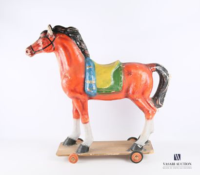 null Wheeled horse in polychrome boiled cardboard on a wooden board with wheels,...