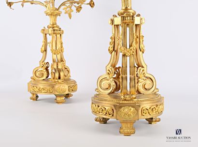 null Pair of candelabras with four lights standing on a round base decorated with...