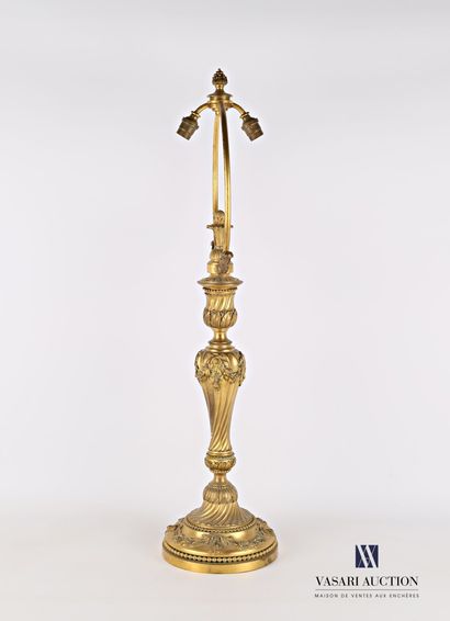 null An important gilt bronze lampstand standing on a round base with a doucine hemmed...