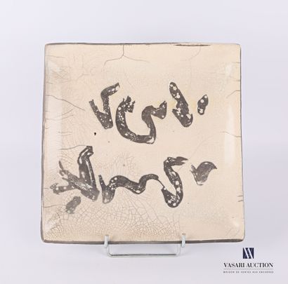 null A stoneware square dish decorated with calligraphic motifs in the basin.

Monogrammed...