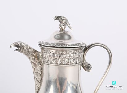 null A silver coffee pot standing on three legs ending in claws, the figured body...