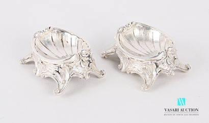 null A pair of silver saltcellars standing on four scrolled feet, the pan decorated...