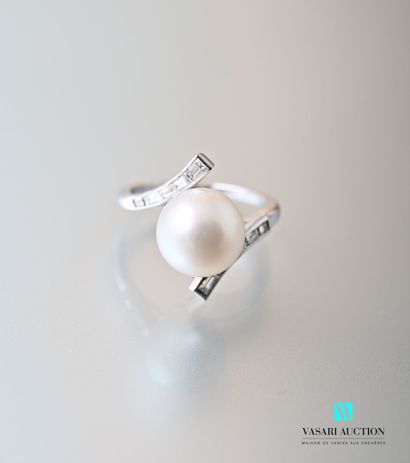 null A platinum ring with a cross-shaped design centered on a white South Sea cultured...