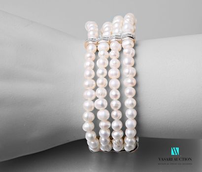 null Bracelet with four rows of freshwater pearls on an elastic cord decorated with...