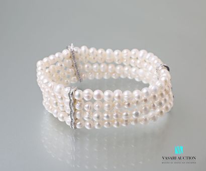 null Bracelet with four rows of freshwater pearls on an elastic cord decorated with...