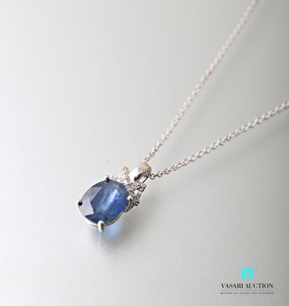null A silver chain and a silver pendant set with an oval sapphire topped by an X-shaped...
