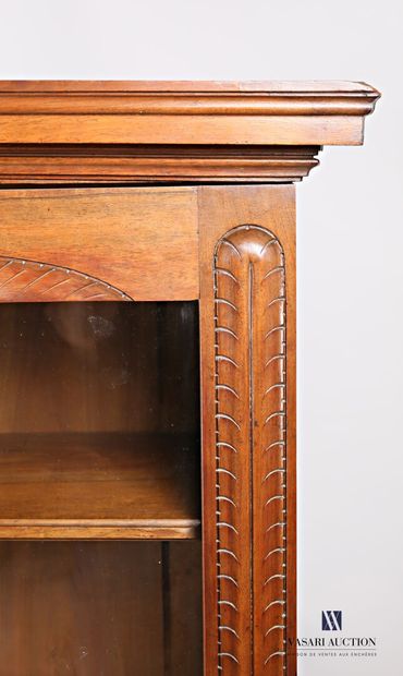 null Natural wood bookcase, molded and carved, it opens on the front with two glass...