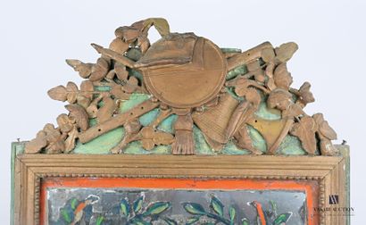 null A molded, carved and bronzed wood mirror hemmed with a frieze of pearls, the...