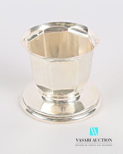 null Silver egg cup, the body with cut sides rests on a pedestal hemmed with fillets.

Master...