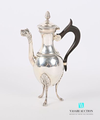 null A silver self-serving coffee pot standing on three arched legs ending in lion...