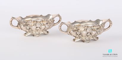 null A pair of silver saltcellars in the form of oblong basins standing on four scrolled...