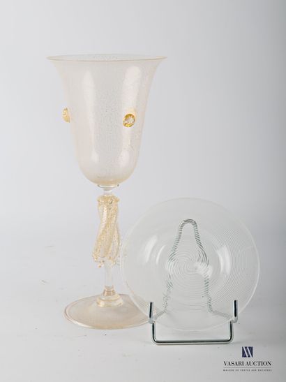 null A tall flared glass on a pedestal, made of translucent blown glass and gold...
