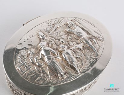 null Small oval silver box, the hinged lid decorated in relief with a market scene...